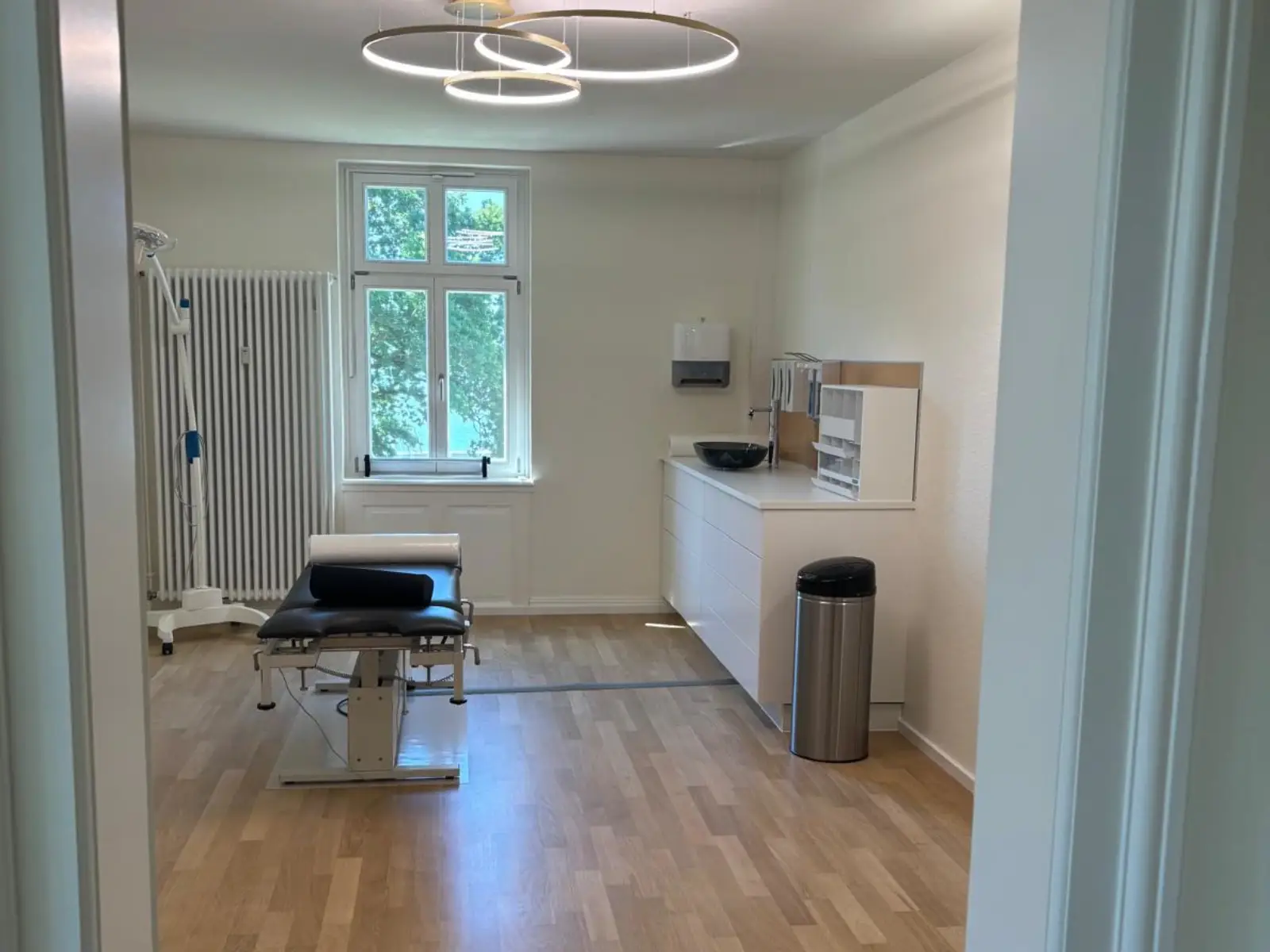 Behandlungsraum der Praxis Prym-Derma mit Seeblick
